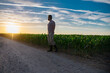 © Volodymyr - Farmer in corn seedling plantation field. Man farmer in corn field examining crop. Farmer business man in corn field. Farmer works in corn field. Agricultural business concept. Growing food, Harvest.