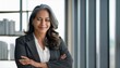 © l1gend - Happy cheerful 45 year old Latin professional mid aged business woman corporate leader, smiling positive mature female executive manager standing in office arms crossed looking at camera, portrait.