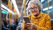 © LifeMedia - An elderly woman in a stylish yellow coat checks her mobile on the subway, embodying independence, connection, and enjoyment of her journey on public transport.