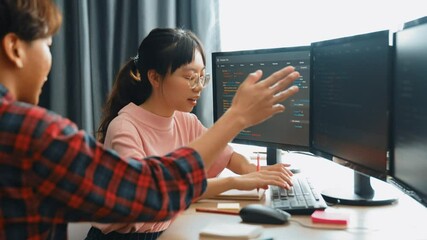 Slow motion back end software developer engineer for computer programming working together on debugging writing computing code, solving complex algorithms display on monitor in office. Burgeoning
