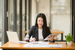 © Thitisak - Asian business woman working and talking at the office