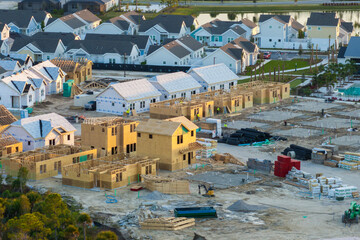 Wall Mural - Development of residential housing in the USA. Wooden frames of new cheap American homes under construction