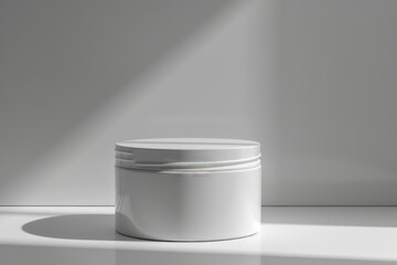 Poster - White jar on white surface with light shining on it.