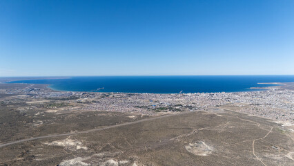 Cityscape of Puerto Madryn in Chubut, Argentina, with the Nuevo Gulf and the Atlantic Ocean in the background.