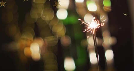 Poster - Sparkler glowing with golden star animation over blurred festive lights background