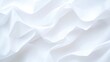 © Whitefeather - The image is a close up of a white fabric with a wave pattern. The fabric is smooth and has a shiny appearance. The wave pattern is subtle and adds a sense of movement to the fabric