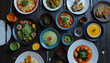 © Natalia - Gourmet dining experience with assorted dishes and colorful beverages on a wooden table