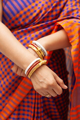 A traditional Bengali Indian woman wearing a saree and displaying her traditional bangles, called 