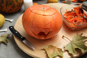 Sticker - Carved pumpkin and Halloween decorations on grey grunge table