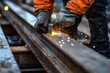 © Ariestia - Close-up of a Worker Welding Steel Beams with Sparks Flying