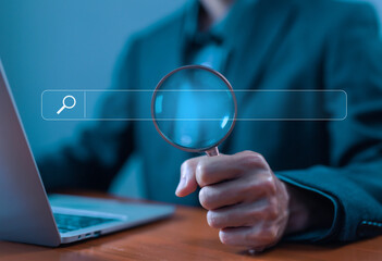 Wall Mural - businessman using a laptop show a search bar. concept of keyword search engines, web browser informa