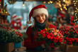 © Татьяна Евдокимова - Young florist is holding a beautiful bouquet of red flowers while working at her flower shop during the Christmas holidays