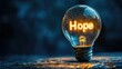 © Artyom - Illuminated lightbulb with 'Hope' inside symbolizes inspiration and positivity