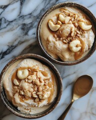 Sticker - Two bowls of vanilla ice cream with caramel sauce and cashews.