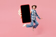 © ViDi Studio - Full body young shocked woman wear blue shirt white t-shirt casual clothes jump high hold use mobile cell phone with blank screen workspace area isolated on plain pink background. Lifestyle concept.