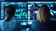 © Nitchalee N. - Two individuals monitor financial data on screens, surrounded by a high-tech environment, analyzing trends and market movements.