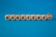 © Liudmila - Turned a dice and changes the German word ‘Barriere’ (barrier) to ‘Barrierefrei’ (barrier free). Beautiful blue background. Business, psychological concept.