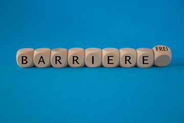 Turned a dice and changes the German word ‘Barriere’ (barrier) to ‘Barrierefrei’ (barrier free). Beautiful blue background. Business, psychological concept.