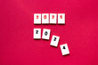 © Nathalie Tabak - chips with red number 2025 above other chips with numbers 2024 falling apart, 2025 coming concept