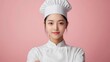 © ifoto - A young Chinese female chef with her arms crossed, wearing white professional attire and a hat, facing the camera directly in front of her upper body against a solid color background