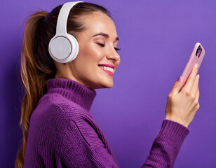 Happy woman listening to music on phone cell smartphone with vibrant purple clothing background