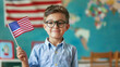 © manassanant - Kid holding US  flag in hand, learn English foreign language course.