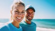 © LoLArt - A close-up of a sporty middle-aged couple smiling at the beach with a clear blue sky.