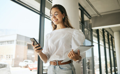 Poster - Business woman, folder and smile with phone in office for text message, checking notifications and networking. Professional, employee and happy with smartphone at workplace for communication or email