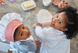 © DavisShared/peopleimages.com - Children, portrait and baking in home with rolling pin, family bonding and together for food prep. Kids, high angle and siblings for learning to cook in kitchen, dough and ingredients for pastry