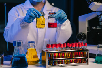 Wall Mural - scientist mixing chemical liquids in the chemistry lab. researcher working in the chemical laborator
