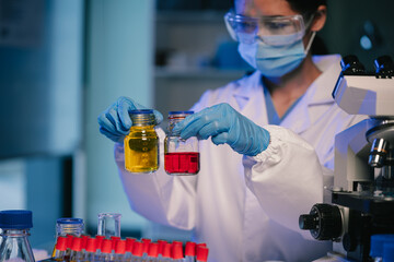 Wall Mural - scientist mixing chemical liquids in the chemistry lab. researcher working in the chemical laborator