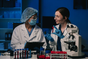 Wall Mural - team scientist mixing chemical liquids in the chemistry lab. researcher working in the chemical labo