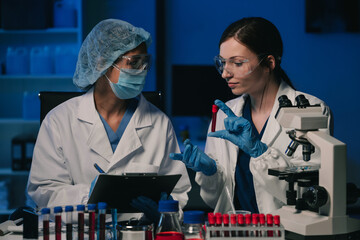 Wall Mural - team scientist mixing chemical liquids in the chemistry lab. researcher working in the chemical labo