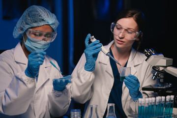 Wall Mural - team scientist mixing chemical liquids in the chemistry lab. researcher working in the chemical labo