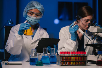 Wall Mural - team scientist mixing chemical liquids in the chemistry lab. researcher working in the chemical labo