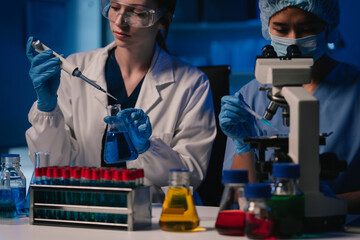 Wall Mural - team scientist mixing chemical liquids in the chemistry lab. researcher working in the chemical labo