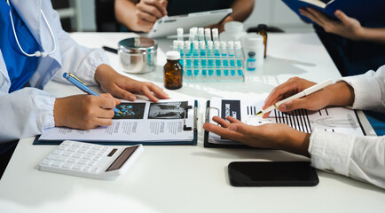 Doctors working together on digital tablet healthcare doctor technology tablet information about drug using computer in a modern office.