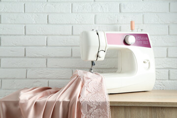 Wall Mural - Sewing machine with fabric on wooden table indoors