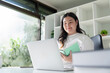 © Natee Meepian - Young Fat Woman Learning and Planning with Notebook in Home Workspace