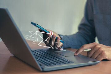 Wall Mural - man uses laptop with notification icon of two new email messages. communication business technology.