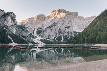  Serene mountain landscape with boats floating on a lake surrounded by rocky peaks