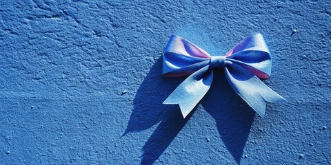 Canvas Print - Blue ribbon tied into a decorative bow on a textured wall.