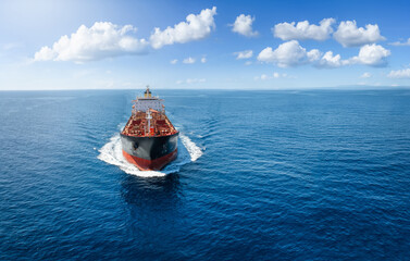 Aerial front view of a chemical goods or oil tanker sailing with speed over the ocean as a concept for the fuel industry