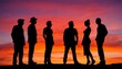 © Vladimir - A group of six people in silhouette, engaged in conversation against a stunning sunset backdrop