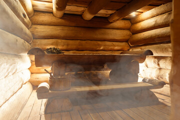 Russian bathroom. Relax in hot sauna with steam. Interior of Finnish sauna, classic wooden sauna with hot steam. Wooden interior baths, wooden benches and loungers accessories for sauna, spa complex