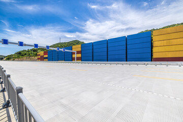 Aufkleber - Stacked containers and empty asphalt road at the port