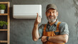 © Premium_art - A man in a work uniform gives a thumbs up in front of an air conditioner unit.