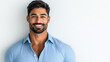 © AI Petr Images - Handsome South Asian man with a confident smile and well-groomed beard dressed in a crisp blue shirt radiating charm against a white background