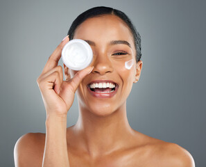 Poster - Woman, skin cream and container in studio portrait with smile, wellness and beauty by background. Girl, person and model with cosmetics, serum and moisturizer product for transformation in Colombia