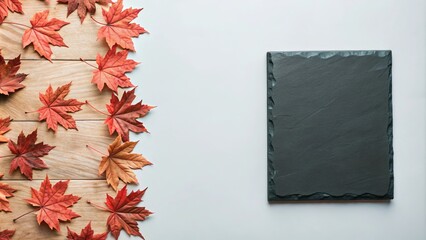 An autumn background featuring colorful red leaves on a blue slate surface, viewed from above with ample copy space.